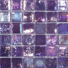 a close up shot of purple glass tiles