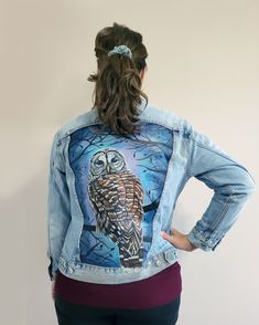 This new denim jacket is hand painted with a heat-set acrylic paint and protected with a top coat. The design features a barred owl with silhouetted branches over a mottled blue and purple background.  Spot or hand washing painted denim is preferable, and hang to dry.  Women's size medium Levi's Ex-Boyfriend Trucker Jacket in a medium wash. Hand Painted Blue Outerwear For Streetwear, Blue Hand Painted Outerwear For Streetwear, Artistic Hand Painted Outerwear For Fall, Artistic Hand Painted Fitted Denim Jacket, Artistic Fitted Hand-painted Denim Jacket, Custom Artwork Long Sleeve Denim Jacket For Fall, Hand Painted Long Sleeve Denim Jacket For Fall, Casual Hand Painted Blue Outerwear, Fall Long Sleeve Denim Jacket With Custom Artwork