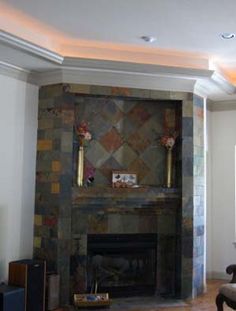 a living room filled with furniture and a fire place under a flat screen tv mounted on a wall