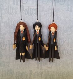 three harry potter dolls hanging from strings