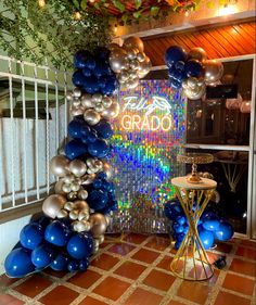 the entrance to grado is decorated with blue, silver and gold balloon garlands