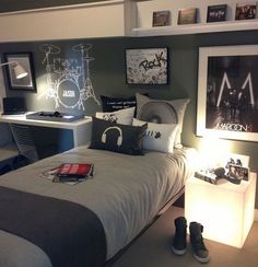 a bed room with a neatly made bed and some pictures on the wall above it