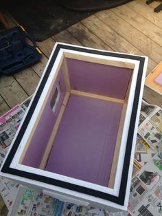 an open box sitting on top of a wooden floor