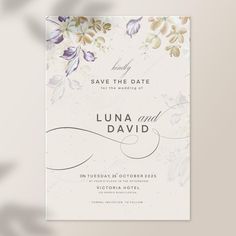 save the date card with watercolor flowers and leaves in white, purple and gold