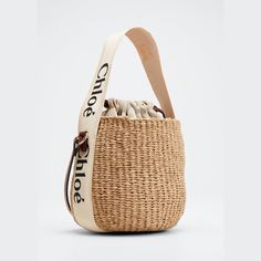 Chloe x Mifuko "Woody" bucket bag in straw, cotton, and leather  Branded flat web top handle  Flat shoulder strap Drawstring closure  Leather lining  Approx. 6.3"H x 6.7"W x 6.3"D Made in Italy Top Handle Jute Bucket Bag, Beige Woven Bucket Bag With Round Handle, Jute Bucket Bag With Bamboo Handle, Beige Bucket Bag With Round Leather Handles, Top Handle Woven Straw Bucket Bag, Beige Bucket Bag With Leather Handles, Natural Bucket Bag With Adjustable Strap, Beige Straw Bucket Bag With Round Handle, Cream Straw Bucket Bag