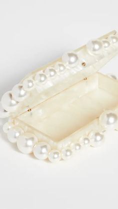 Featuring a structured, rectangular silhouette accented with bold bead trim, this Cult Gaia clutch is a polished bag from one our favorite brands for statement accessories. Acrylic Structured design with bead trim Snap closure at top Unlined Box Clutch, Cult Gaia, Structure Design, Beaded Trim, Eos, Beads