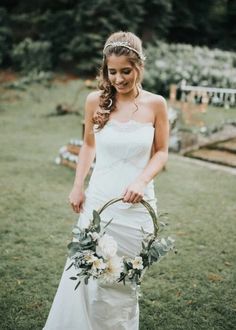 a woman in a wedding dress holding a flower basket