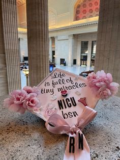 a graduation cap with pink flowers on it and the words, like as full of tiny miracles