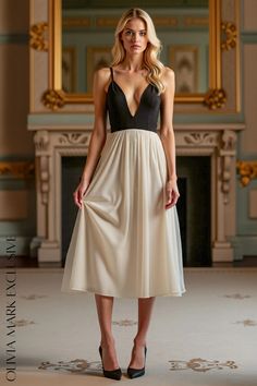 Olivia Mark - Elegant Black and Ivory Midi Dress with Deep V-neckline and Flowy Skirt Ivory Midi Dress, Black Dress Elegant, Flowing Skirt, Black And Cream, Flowy Skirt, Plunging Neckline, Olivia Mark, Mid Calf, Bodice