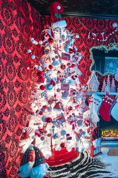 a white christmas tree with red and silver ornaments