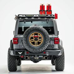 the back end of a jeep with two red lights on it's roof rack