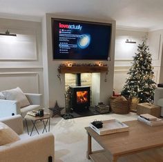 a living room filled with furniture and a flat screen tv mounted above the fire place