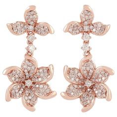 two pairs of earrings with white and pink stones in the shape of flowers on each ear