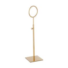 a gold metal stand with a circular mirror on it's top and a square base