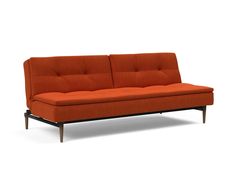 an orange couch sitting on top of a white floor