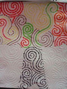 a quilted tree with swirls on the front and sides, in bright colors