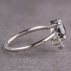 a white gold engagement ring with an oval cut diamond and baguettes on the side