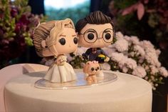 a wedding cake topper with a bride and groom on it