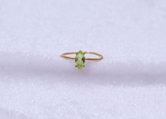 "Materials Gold, Rose gold, White gold Gemstone: Natural Peridot Peridot Ring / 14k Gold Peridot Wedding Ring / Anniversary Ring / Marquise Ring / Stacking Ring / Dainty Ring / Gemstone Ring / Prong set Item Details * Made to Order * Material: 14K Solid Gold (If 18K is needed, please inquire) * Gold Color Choice: Rose Gold, Yellow Gold, White Gold * Total CTW: .50 crt( 4 mm) (varies by size of the ring) * Width of Band: 1.30mm Ready to Ship in 7-10 Business Days * Also available in other gemston Yellow Gold Peridot Stackable Rings For Wedding, Yellow Gold Solitaire Peridot Rings, Yellow Gold Peridot Solitaire Rings, Peridot Rings In Yellow Gold For Promise, Yellow Gold Peridot Promise Ring, Yellow Gold Peridot Rings For Promise, Wedding Ring With Hallmarked Peridot, Peridot Wedding Ring, Ring Marquise