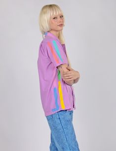 This button up style is the definition of easy. Put on this shirt and you will feel like you are on instant vacation. This button down is a boxy unisex cut with a flat hem, glossy bright buttons, and a front chest pocket. Features colorful yet subtle hand paint-stamped side seam, sleeve, and collar stripes. Make it a fit with the Neon Lines Jeans! Shop all Graphic Button Ups Please note, due to the hand-done process, the design will vary slightly.True to size. Unisex sizes Mini- 4XL 100% cotton Snap Pants, Button Up Style, Button Ups, 5 Panel Hat, Perfect Blouse, Lined Jeans, Panel Hat, Hand Paint, Up Styles