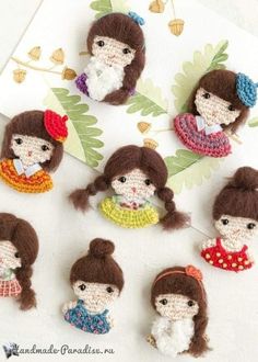 small crocheted dolls are displayed on a table