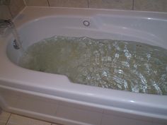 a bathtub filled with water in a bathroom