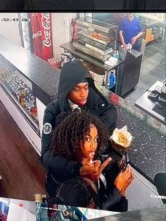 two women sitting at a counter in a store