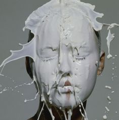 a woman with her face covered in milk