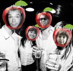 a group of people with apples on their heads