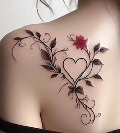 the back of a woman's shoulder with flowers and leaves on it