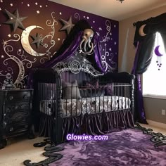 a baby crib in front of a purple wall with stars and moon decorations