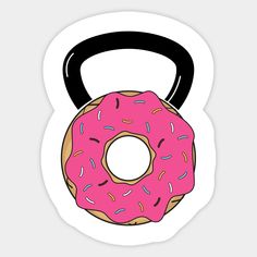 a pink donut with a black handle is shown in the shape of a kettle