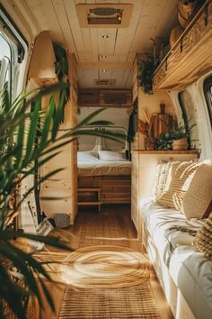 the interior of a camper van with wood flooring and plants in the foreground