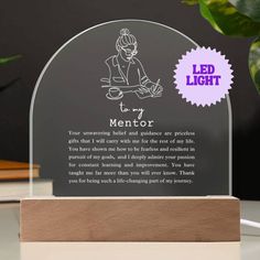 a clear glass plaque with the words mentor on it