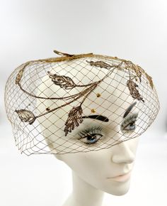 Vintage gold birdcage hat featuring; a bubble shape of slightly stiff gold mesh or netting embroidered with vining leaves and sprinkled with gold metallic rondelles crown has a gold velvet ribbon "H" where the hat could be pinned to the hair with no labels or tags this measures 30 inches around the inside of the brim in good, preworn, vintage condition with no major issues of note, the ribbon on the crown has darkened at the edges as shown in the pictures we are happy to ship internationally and Gold Velvet, Velvet Ribbon, Bird Cage, Hair Pieces, The Crown, Fascinator, Vintage Gold, Headpiece, Caps Hats