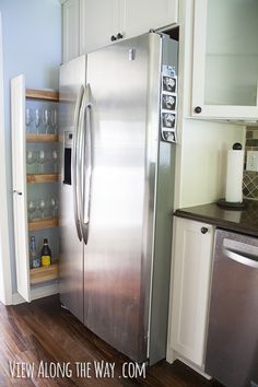 a stainless steel refrigerator in a white kitchen