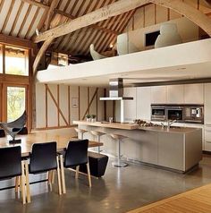 an open floor plan shows the kitchen and living room in one section, dining area on the other