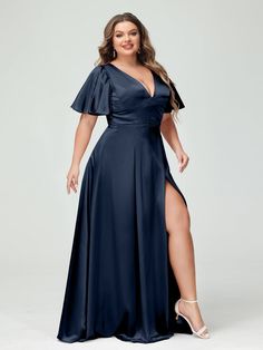 a woman in a dark blue dress posing for the camera with her legs spread out