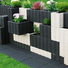 several planters are placed on the side of a wall