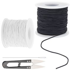 a spool of thread, scissors and wire on a white background