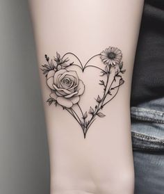 a heart shaped tattoo with flowers on it