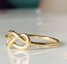 were highly symbolic in vintage jewelry, symbolizing infinite love. This would make a wonderfully unique wedding or engagement ring due to the romantic symbolism. The love knot/infinity knot represented the union of two souls arranged in the form of an infinity love knot. :) Ring weighs 1.3 grams. Band is stamped for 14k gold and is nice and sturdy despite it's dainty appearance. The ring is very comfortable to wear due to the low profile. The setting face measures 12.5 mm E to W and 8 N to S. C Infinity Ring Detail Wedding Jewelry, Wedding Infinity Jewelry With Ring Detail, Handmade Infinity Rings For Anniversary, Symbolic Infinity Jewelry For Anniversary, Handmade Infinity Jewelry For Anniversary, Cabin Core Aesthetic, Infinity Knot Ring, Cabin Core, Love Knot Ring