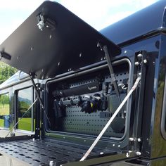 the back end of a black truck with its doors open