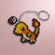 a keychain made out of legos is shown with an image of a bird