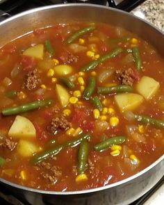 a pot filled with stew and vegetables on top of a stove