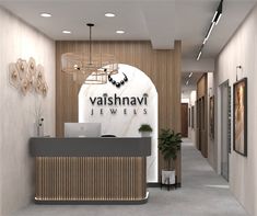 the front desk of a jewelry store with a laptop on it's desk and an advertisement for vashnavi jewels