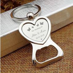 Personalized Bottle Opener Heart KeychainThe Personalized Bottle Opener Heart Keychain from Forever Gifts is a versatile and thoughtful gift perfect for any occasion. This custom heart keychain doubles as a practical bottle opener, making it a useful accessory for everyday use. The heart shape adds a touch of charm and personalization, making it a great gift for loved ones or special recipients. Made with high-quality materials, this keychain is durable and long-lasting. Whether you're looking for a gift for a friend, family member, or significant other, the Personalized Bottle Opener Heart Keychain is a unique and practical choice. Perfect for anyone who enjoys both functionality and style.Free Engraving 3 lines up to 15 characters per lineMaterial : Stainless SteelDimensions3.1" long Wid Birthday Party Souvenirs, Etching Ideas, Engraved Promise Rings, Keychain Bottle Opener, Personalized Bottle Opener, Forever Gifts, Photo Logo Design, Bottle Opener Keychain, Heart Keyring