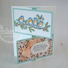 a card with two birds sitting on a tree branch, and a tag attached to it