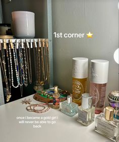 an assortment of perfumes and jewelry on a counter with the words 1st corner above it