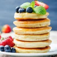 stack of pancakes with fresh fruit on top